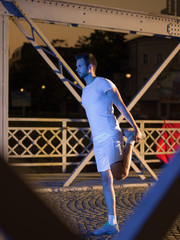 man jogging across the bridge in the city