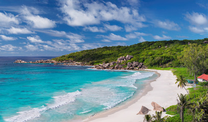 Panorama of beautiful Grand Anse Beach in La Digue island, Seychelles. Summer vacation and holiday travel concept.  - obrazy, fototapety, plakaty