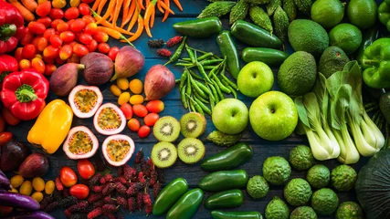 Poster Flat lay of fresh  fruits and vegetables for background, Different fruits and vegetables for eating healthy, Colorful fruits and vegetables on blue plank background © peangdao