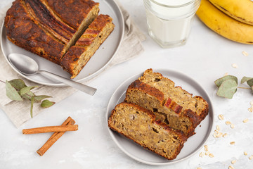 Sliced banana bread with cinnamon in gray plates. Gray background. Vegan Healthy Food Concept. Top view