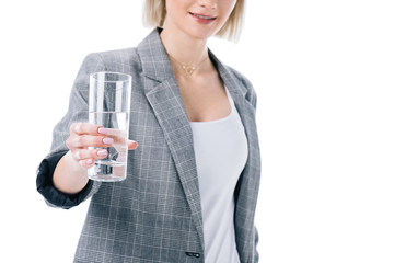 cropped view of woman holding glass of water, isolated on white