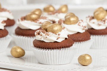 Easter Cupcakes Decorated With Golden Chocolate Eggs. Home Baked.