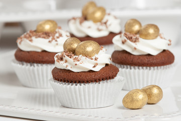 Easter Cupcakes Decorated With Golden Chocolate Eggs. Home Baked.