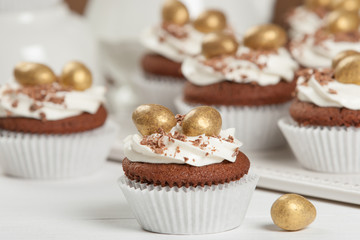 Easter Cupcakes Decorated With Golden Chocolate Eggs. Home Baked.
