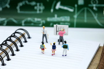 Miniature people : children with book and school background. Back to school concept