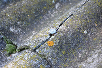 Cracked asbestos sheets old roof. Asbestos Shingles Repair and Removal. House asbestos roof removal.