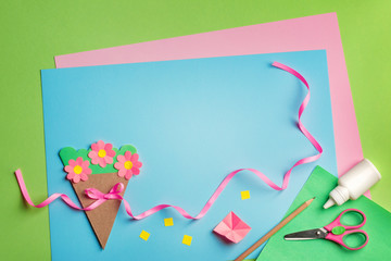 paper crafts for mother's day, 8 march or birthday. Small child doing a bouquet of flowers out of...