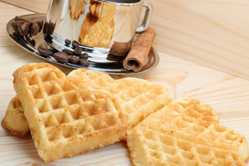 Cookies in the shape of heart on a wooden background with a cup of coffee, cinnamon and anise