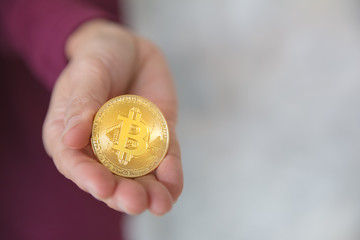 woman holding bitcoin