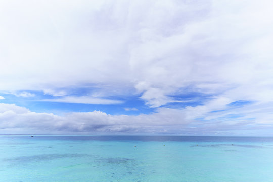 Beautiful white clouds , blue sky and crystal clear turquoise sea in tropical Maldives island