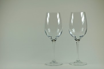 Two empty transparent glass on gray background.