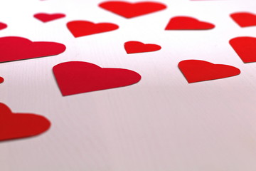 Paper baked red hearts on a white background.