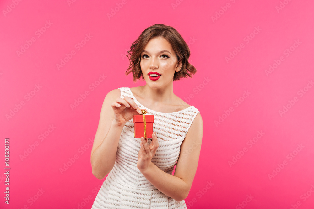 Sticker Portrait of a pretty girl dressed in dress holding gift