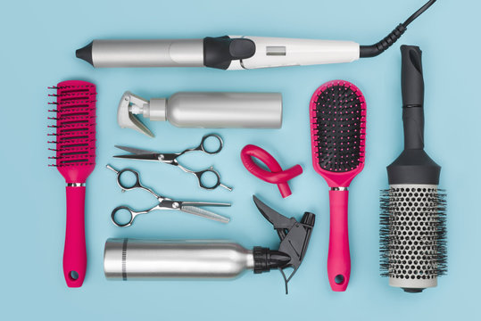 Professional hairdressing tools isolated on blue background, view from above