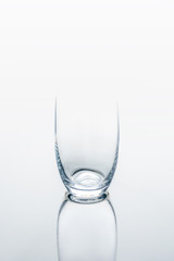 one glass on white reflecting table
