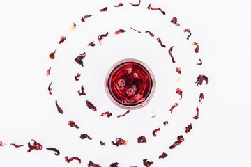top view of cup with hibiscus tea in spiral isolated on white
