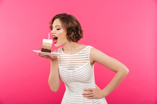 Portrait of a young girl eating a piece of cake