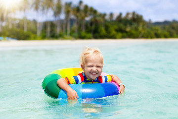 Fototapeta na wymiar Child on tropical beach. Sea vacation with kids.