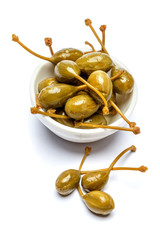 heap of marinated capers on white background