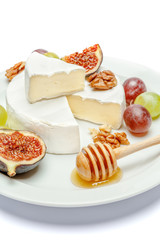 Round brie or camambert cheese on the plate white background