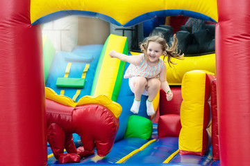 Fototapeta na wymiar Child jumping on playground trampoline. Kids jump.