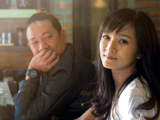 Asian beautiful and attractive woman sitting with asian man and flirting in coffee shop 