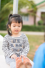 Little asian girls playing with her friend outdoor in daycare