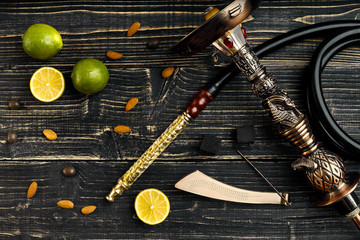 Dismantled parts of hookah on a wooden background with lime frui