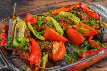 Turkish cuisine, eggplants stuffed with minced meat and cooked with fresh tomatoes and bell peppers in a baking dish.