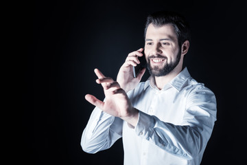 Mobile connection. Positive nice cheerful man making a call and smiling while touching the virtual screen