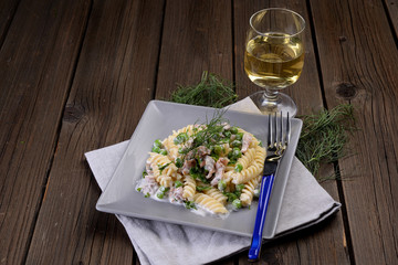 Plate of pasta fusilli with peas and salmon cream