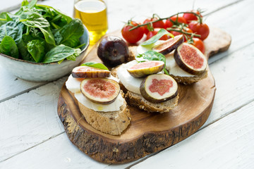 fresh ripe sliced fig on toast bread mozzarella cheese Italian crostini dish light lunch starter