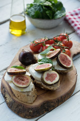 fresh ripe sliced fig on toast bread mozzarella cheese Italian crostini dish light lunch starter