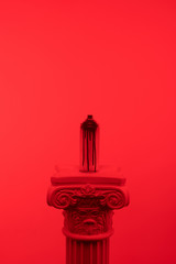 red toned picture of aerosol paint in can on column