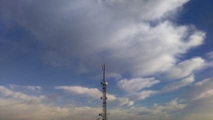 television broadcast tower against cloudy sky
