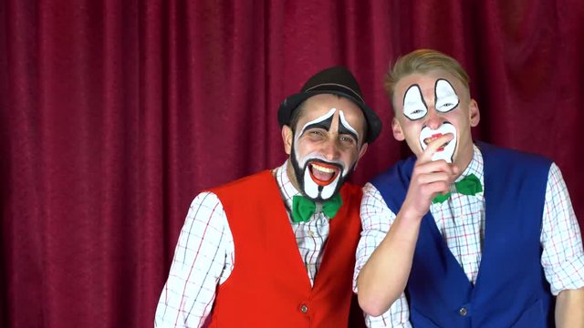 Two clowns laughing