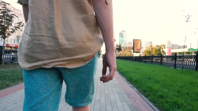 Man put Us money in pocket of blue jeans