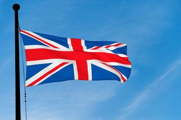 UK Flag waving over blue sky (digitally generated image)
