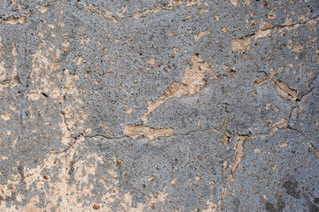 Concrete wall with peeling blue paint