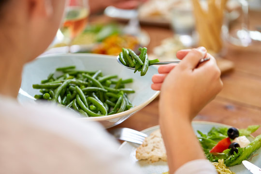 Close Up Of Woman Eating Green Beans