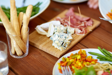 blue cheese and breadsticks on table