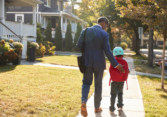 Businessman Father Walking Son On Scooter To School