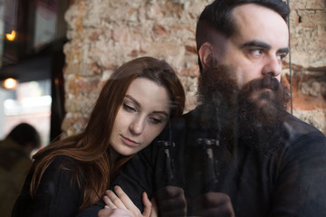 Couple in struggle or conflict, sad and distant with cold looks on their faces. Look away from each other. Problems in relationship, breakup concept.