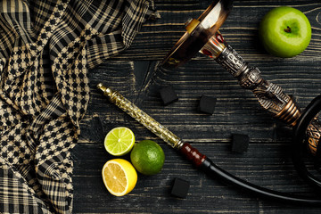 Dismantled parts of hookah on a wooden background with lime and 