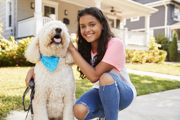 Portrait Of Girl With Dog On Suburban Street