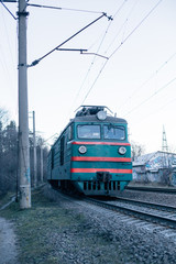 Old and vintage retro train with soviet style, passes by rails. Concept public transportation and ecology pollution