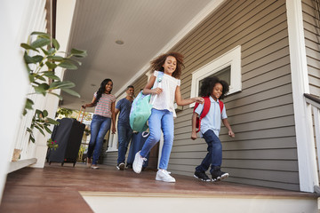Fototapeta premium Family With Luggage Leaving House For Vacation