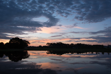 Fototapeta na wymiar Sunrise Reflecting over Smooth Water