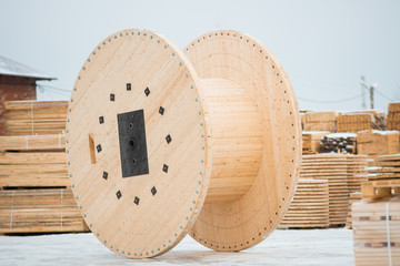Large empty wooden coil. The new cable drum at the industrial area. Outdoors