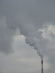 Industrial Smoke Pipe on a Grey Sky / Smoke air emissions from an CHP pipe on a grey sky in windless winter day